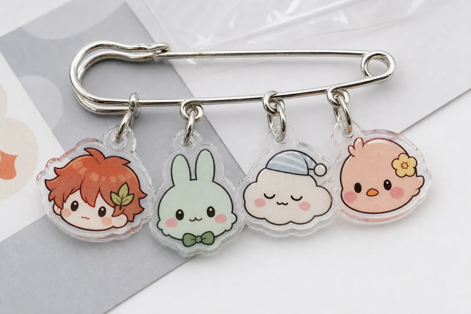 Acrylic charm safety pin brooch samples with chibi mascot characters, suitable for event merchandise, fan goods and custom OEM badges.