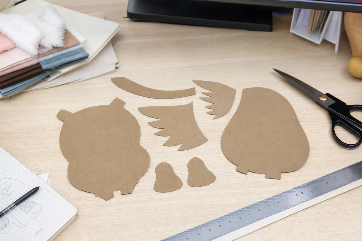 Paper plush patterns cut and checked on a work table
