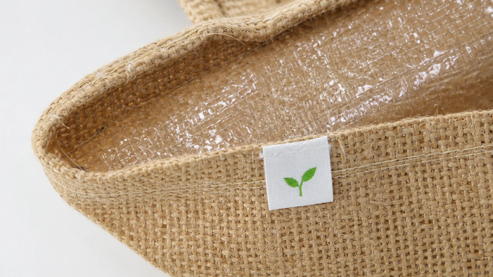 Close-up of coarse jute bag weave and inner PP lamination used to review natural fiber variation