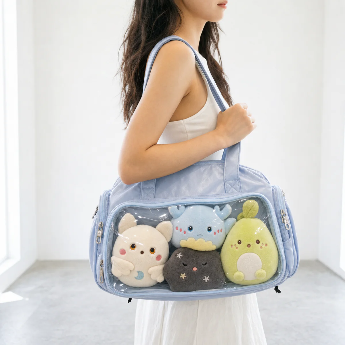 large Boston ita bag worn on the shoulder with original plush inserts visible through the clear front window