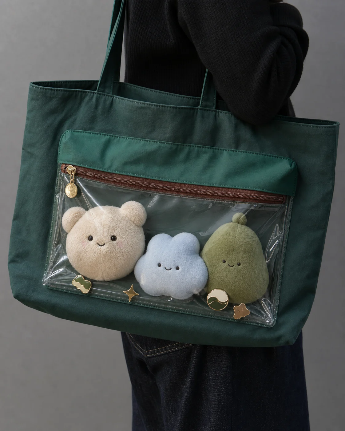 large tote ita bag worn on the shoulder with original plush items visible through the clear window