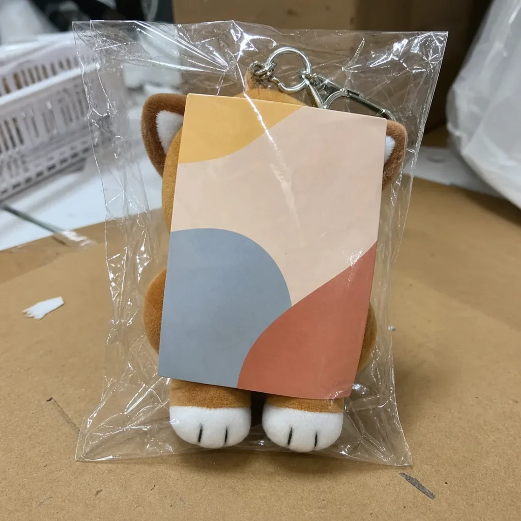 backing card slipped in front of a custom plush and obscured the character face