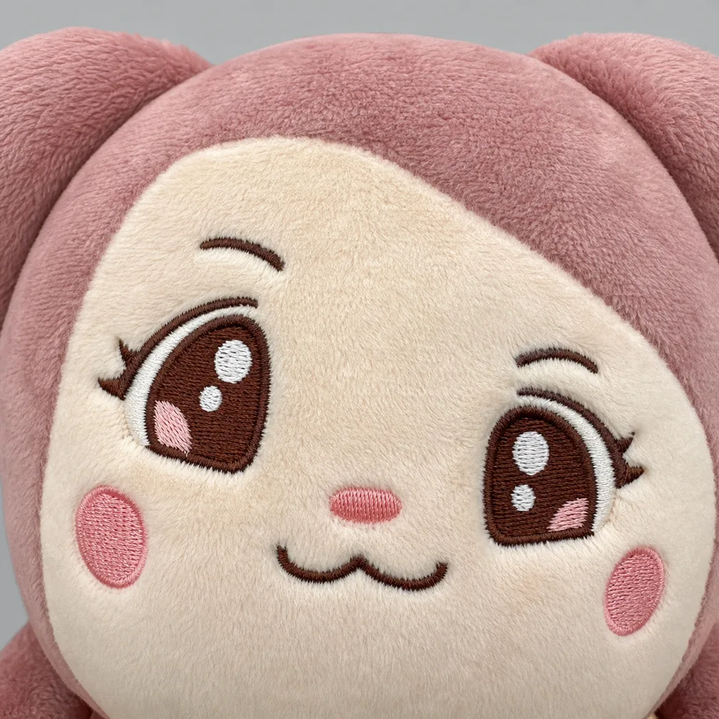 defective plush face with visibly misaligned embroidered eyes