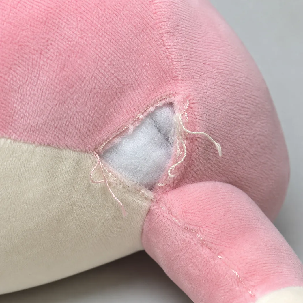 open plush seam with white stuffing visible through the split