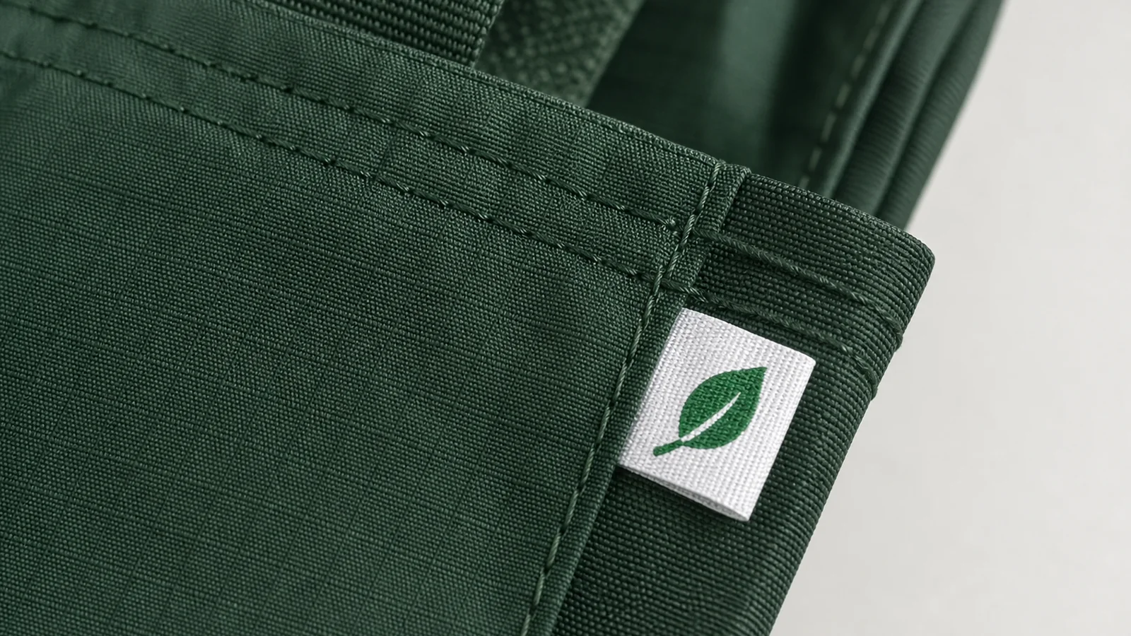 Macro photo of RPET ripstop fabric and sewn leaf label for recycled material wording review