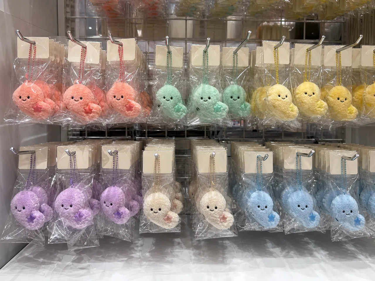 custom plush charms in OPP bags and backing cards on hook display