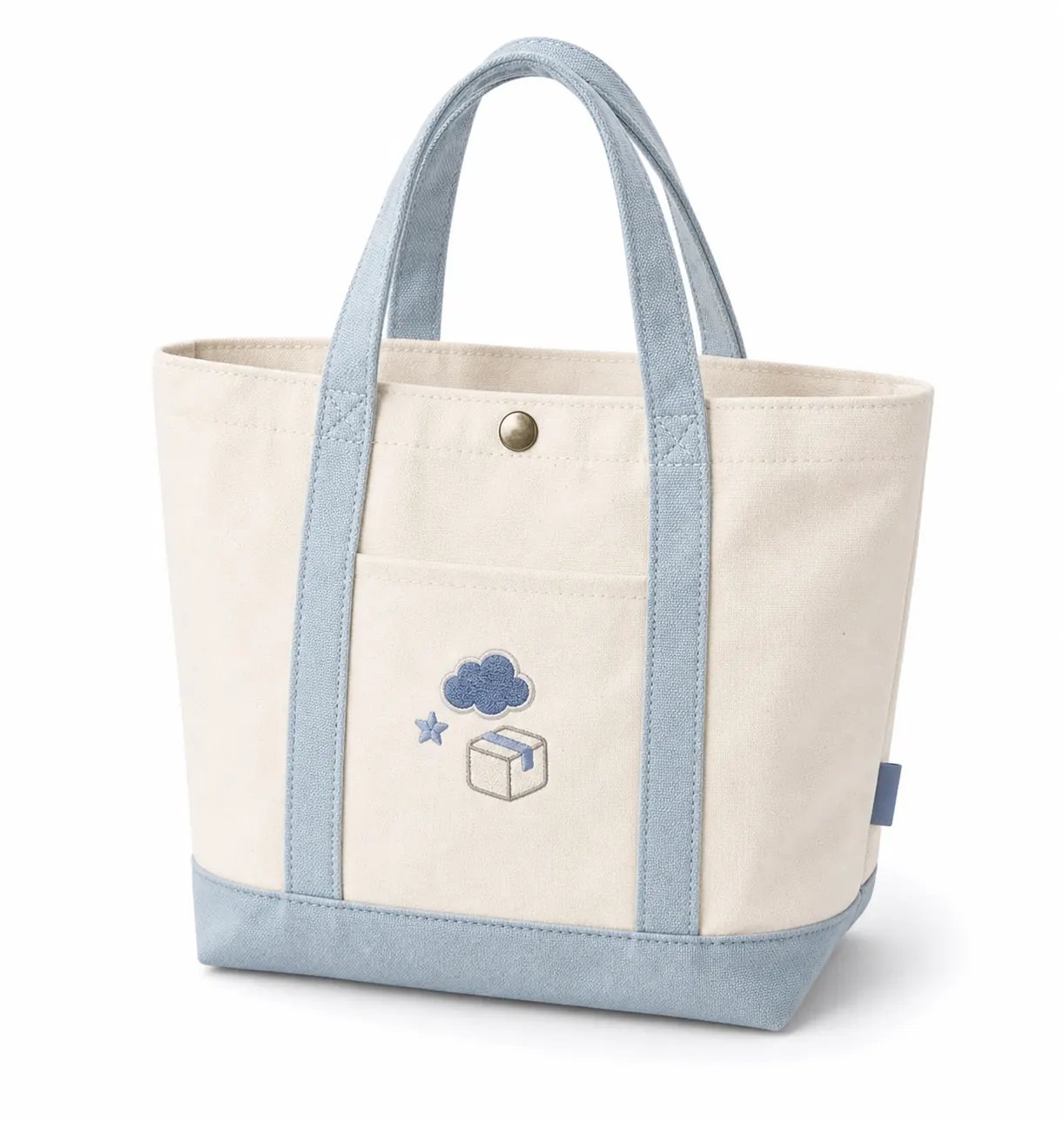 Canvas tote bag with blue handles, snap button, front pocket, gusset, and embroidered patch