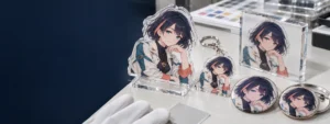 Side-by-side UV and offset print results on button badges and acrylic merchandise using the same original character artwork